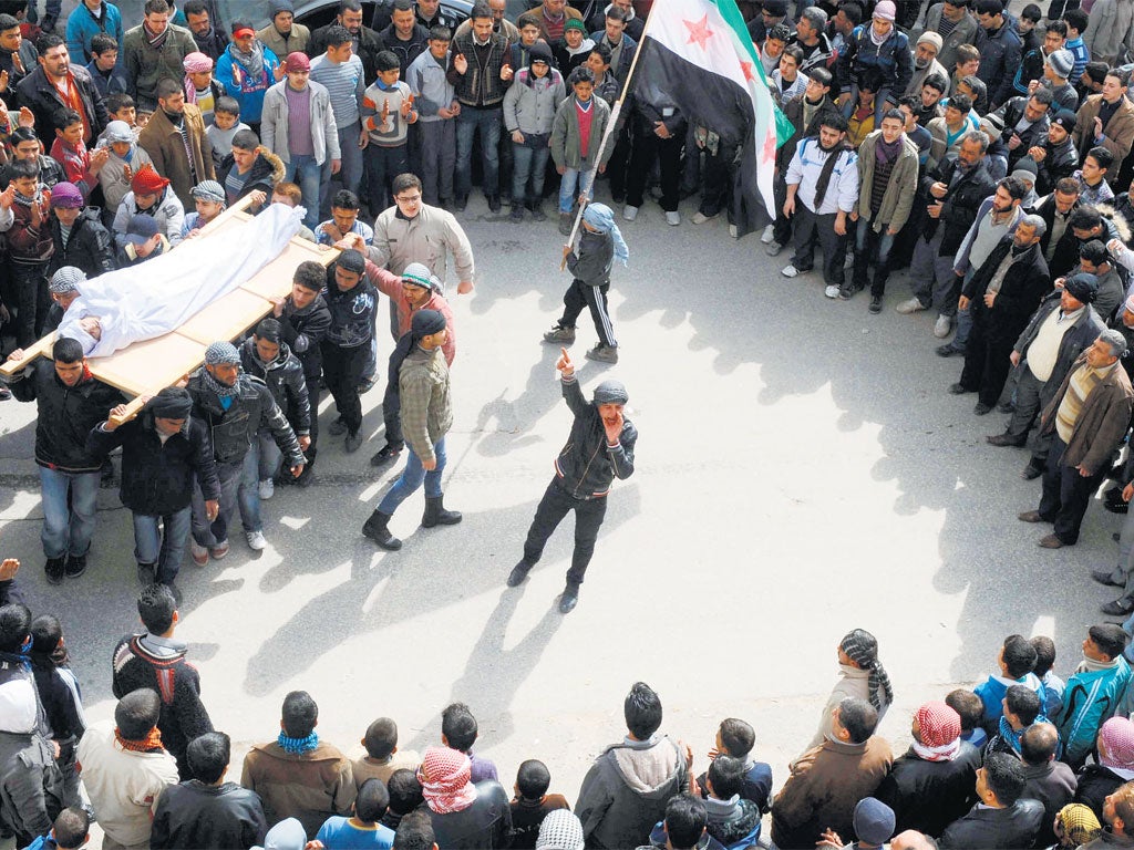 Rebel supporters at the funeral of a young victim of the conflict in north-west Syria