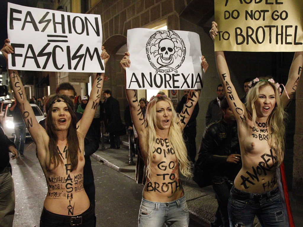 February 24, 2012: Activists from Ukrainian women's rights movement Femen, demonstrate in front of the Versace show during Milan Fashion Week in Milan.