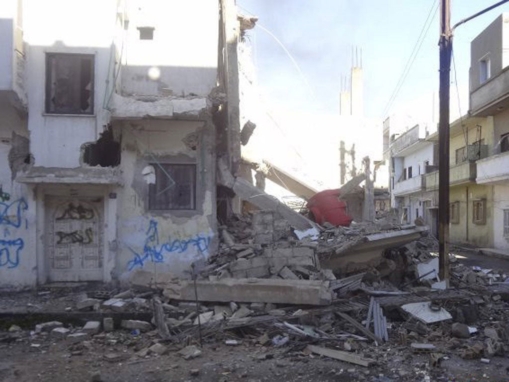 Debris and damaged houses are seen after government forces shelled the opposition-held area of Bab Amro, in Homs