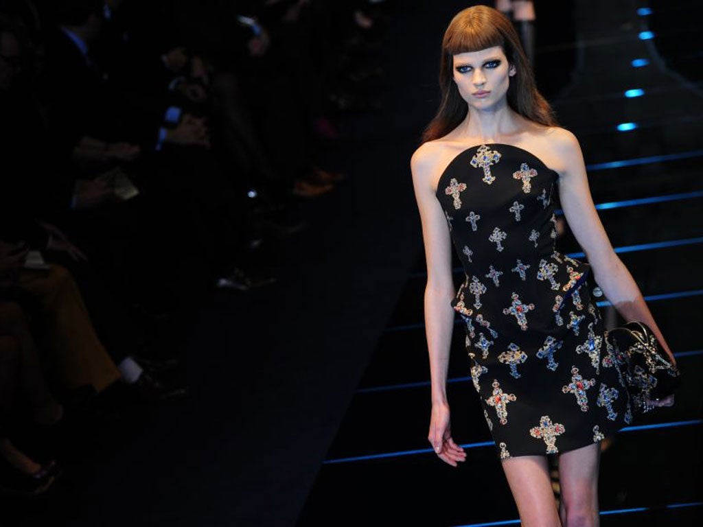 Coats and dresses in black wool were embellished with glittering visigoth crucifixes