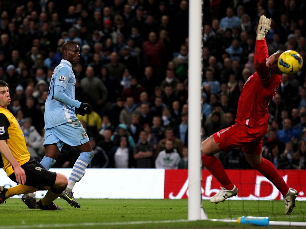 Mario Balotelli scores the opening goal past Blackburn keeper Paul Robinson