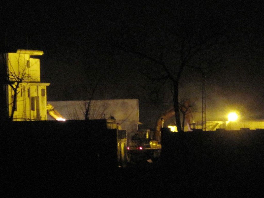 Workers bulldoze the compound where Osama bin Laden was killed