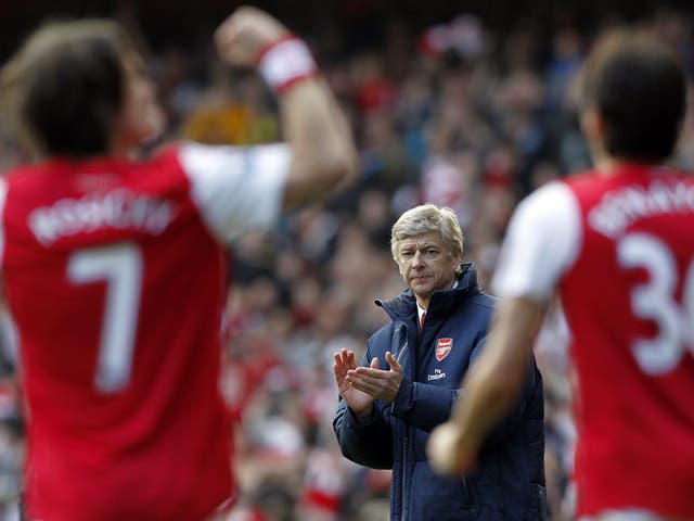 Arsene Wenger, Manager of Arsenal, applauds whilst Arsenal's Czech Republic player Tomas Rosicky (L) celebrates scoring 