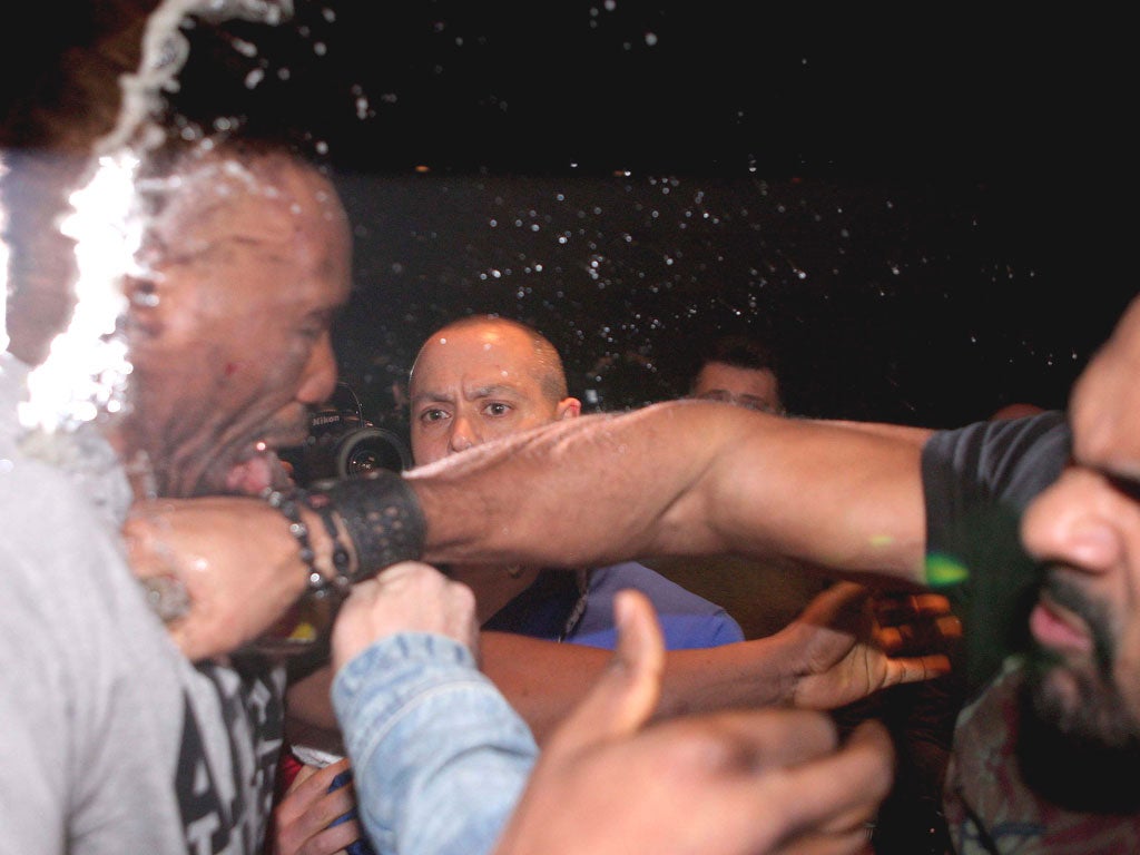 David Haye (right) hits Dereck Chisora during their press
conference brawl in Germany