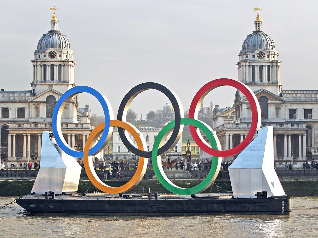 Olympic rings are towed on the Thames yesterday past the Royal Naval College at Greenwich, where equestrian events will be held in August