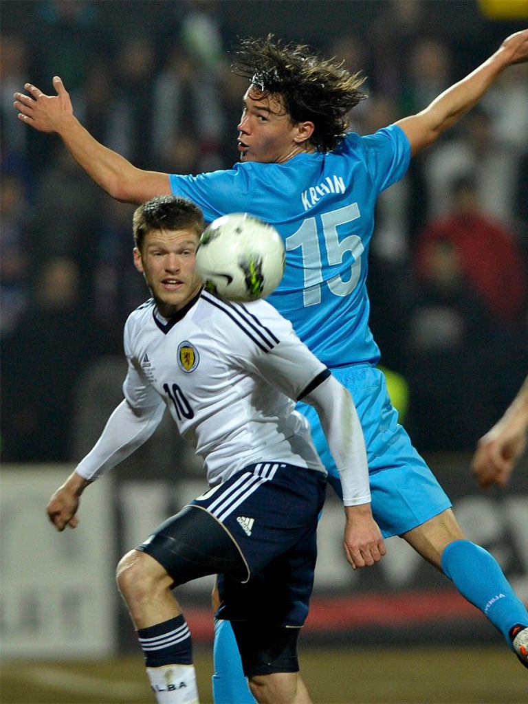 Scotland's Jamie Mackie (left) is challenged by Rene Krhin