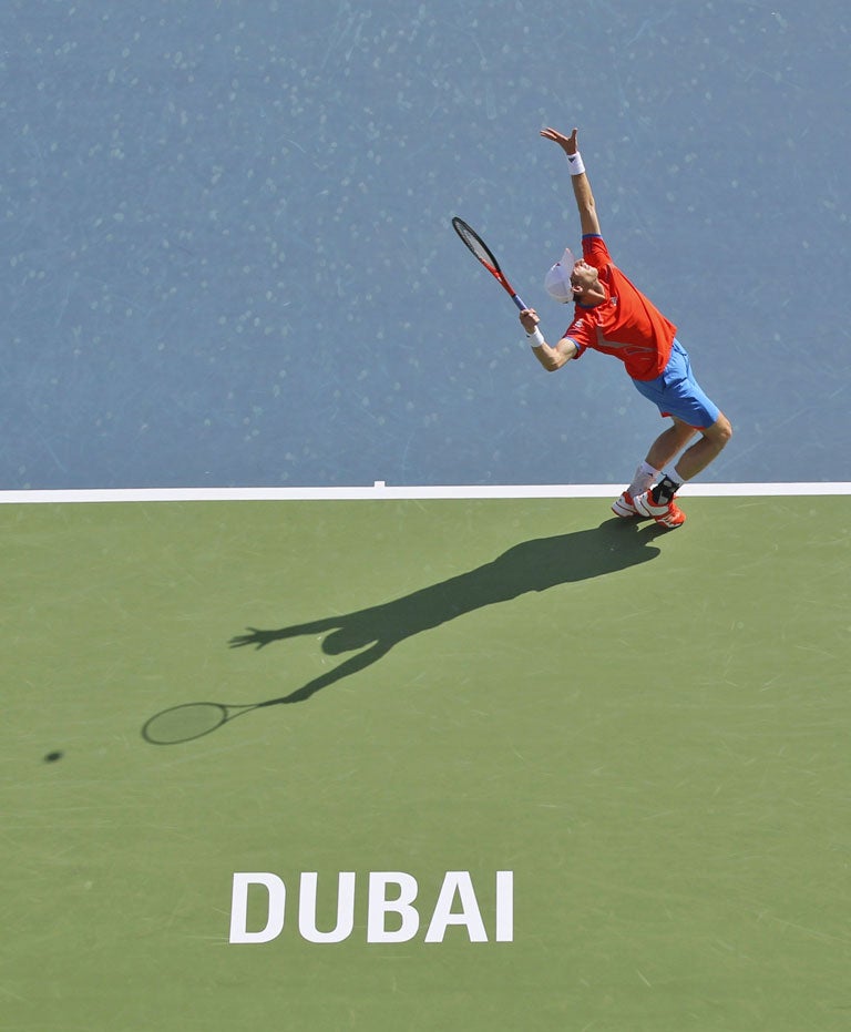 Andy Murray serves to Tomas Berdych during their quarter-final yesterday