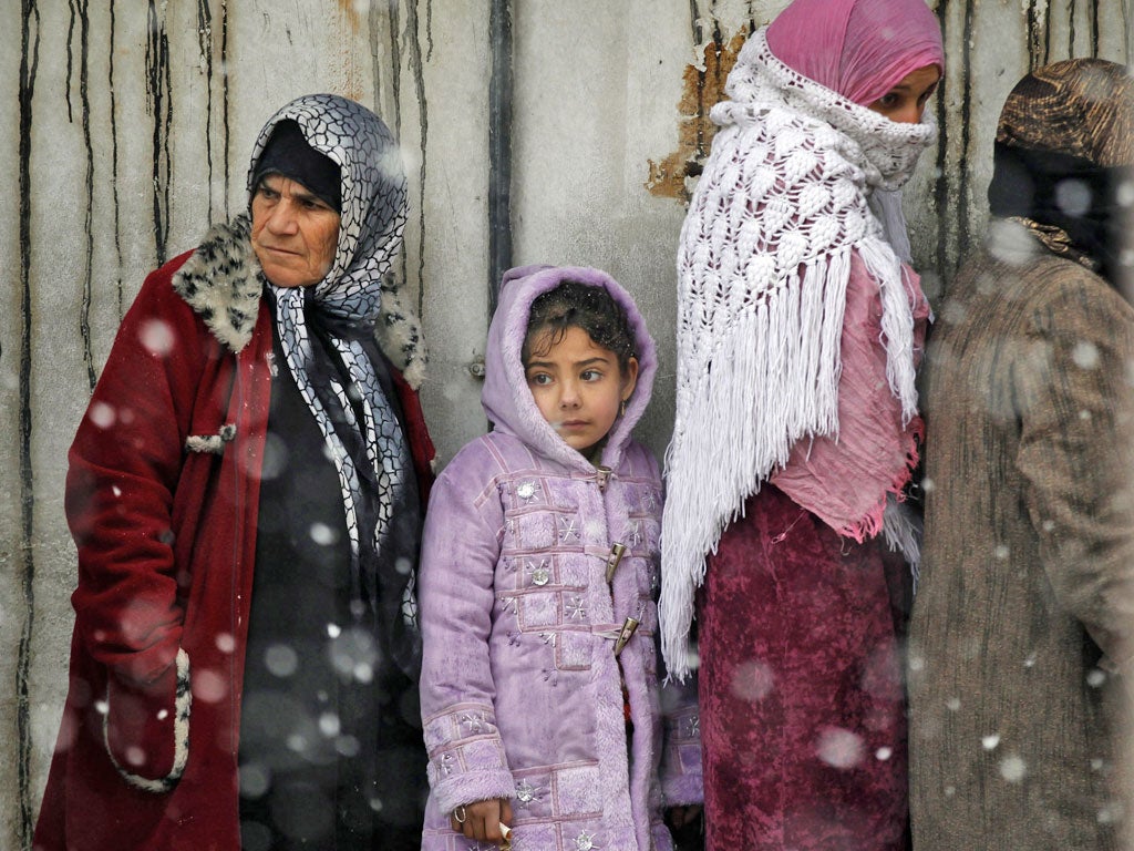 Both the old and young wait to buy bread in Al Qusayr, three miles from Homs