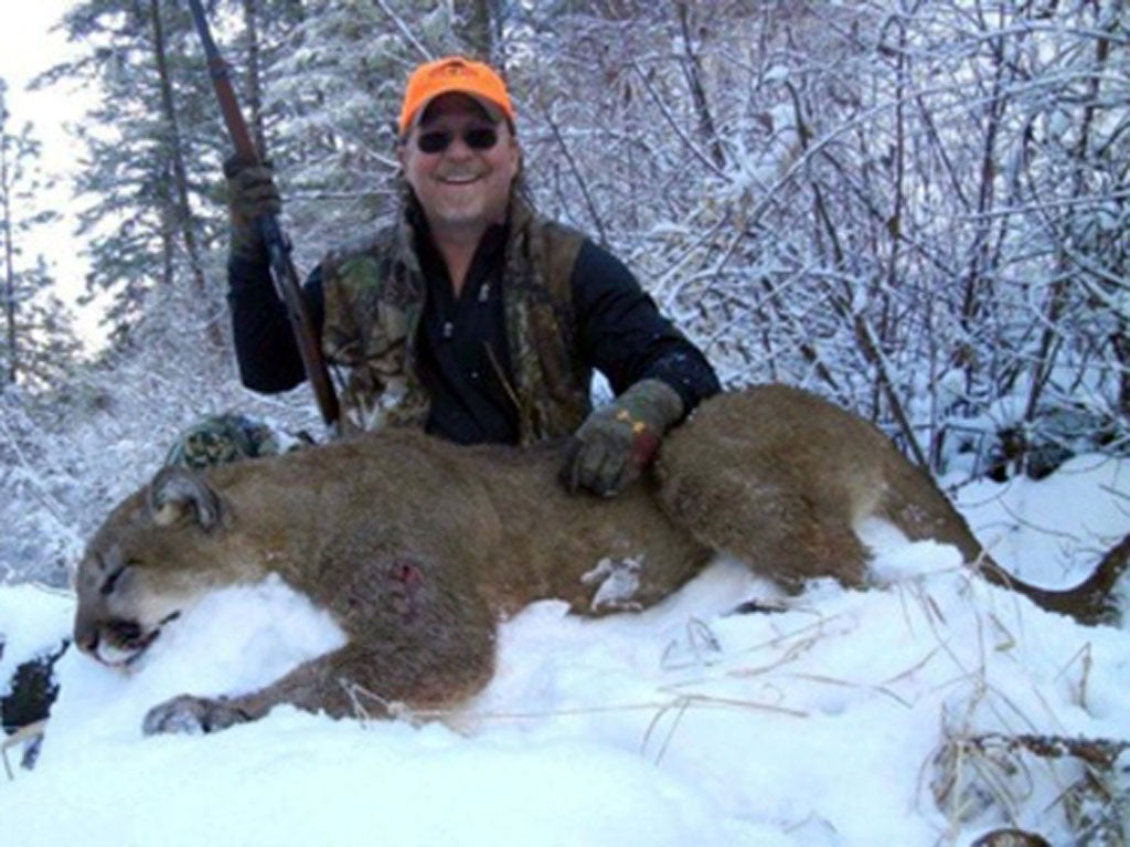 Dan Richards, of Upland, president of the California Fish and Game Commission, shows off a mountain lion he shot during a recent hunting trip to Idaho.
