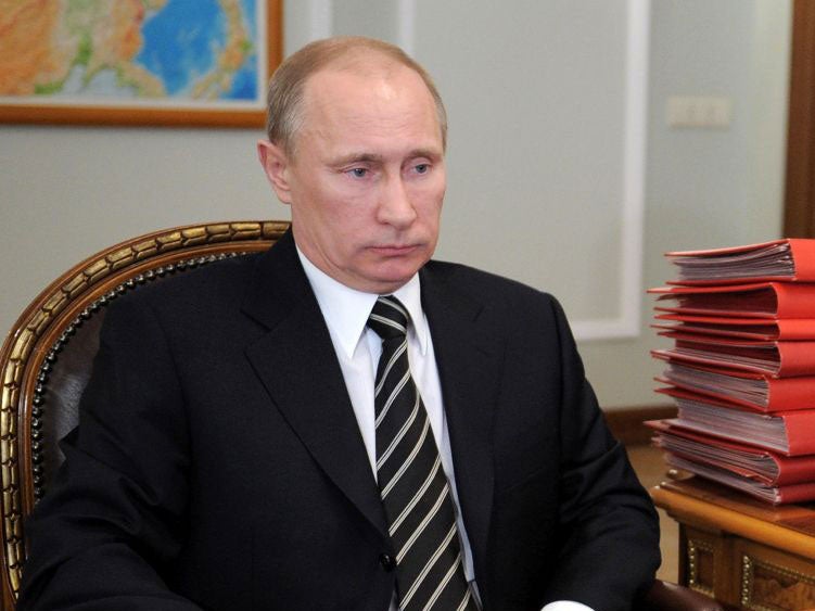 Vladimir Putin sits in his study in the Novo-Ogaryovo residence outside Moscow today