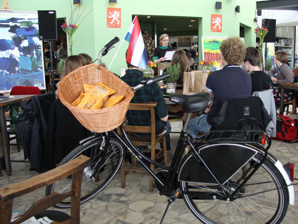 Novelist Sanneke van Hassel reads her work. The Dutchie bicycle on display before being awarded as a prize
