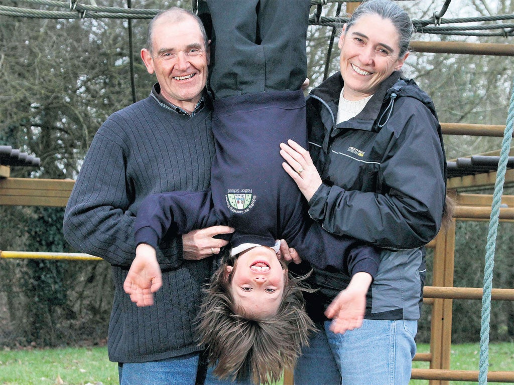 Family time: Lt-Cdr Sam Dunbar, her husband Mark, and their adopted son, ‘Dunbar Junior’