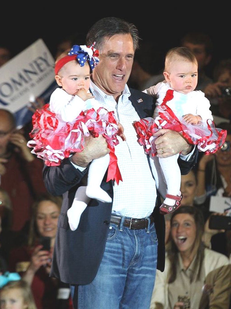 Republican presidential candidate, Mitt Romney holds two babies during a rally in Knoxville, Tennessee