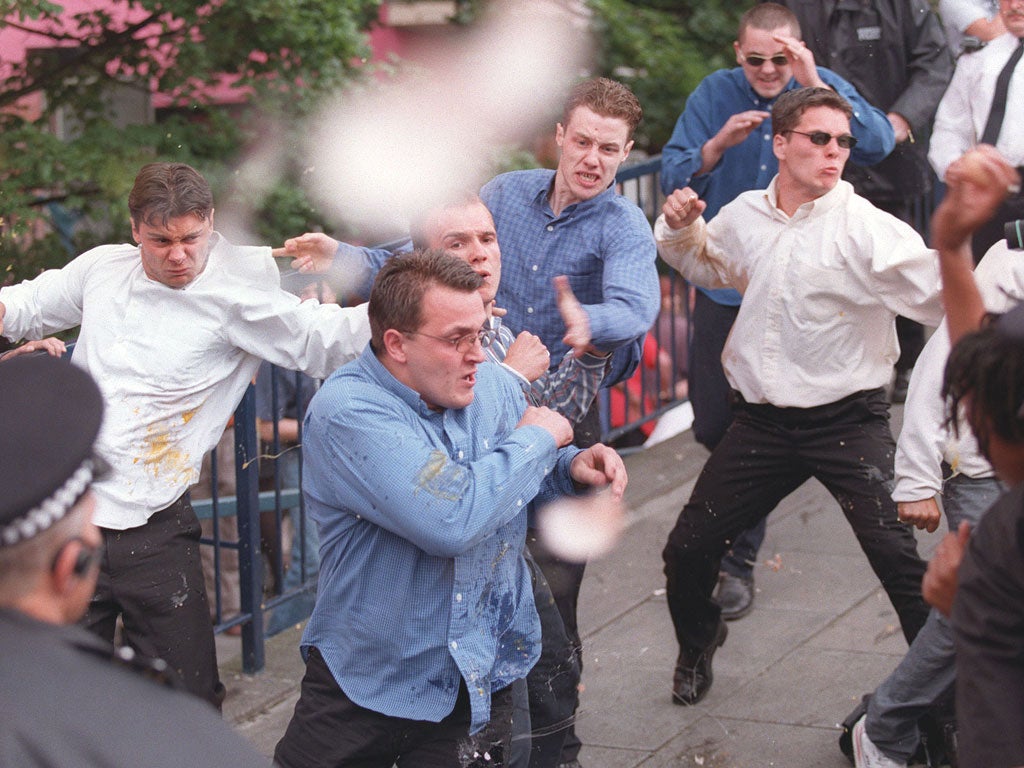 Luke Knight (left), Neil Acourt (second left), David Norris (centre back, wearing blue shirt), Jamie Acourt (white shirt, throwing punch) and supporters are pelted with eggs on 30 June 1998 after giving evidence to the Macpherson public inquiry into the police handling of the Stephen Lawrence murder case