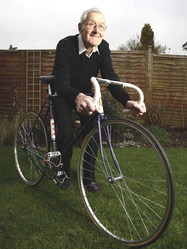 Tommy Godwin at home in Solihull with the bike on which he won the medals