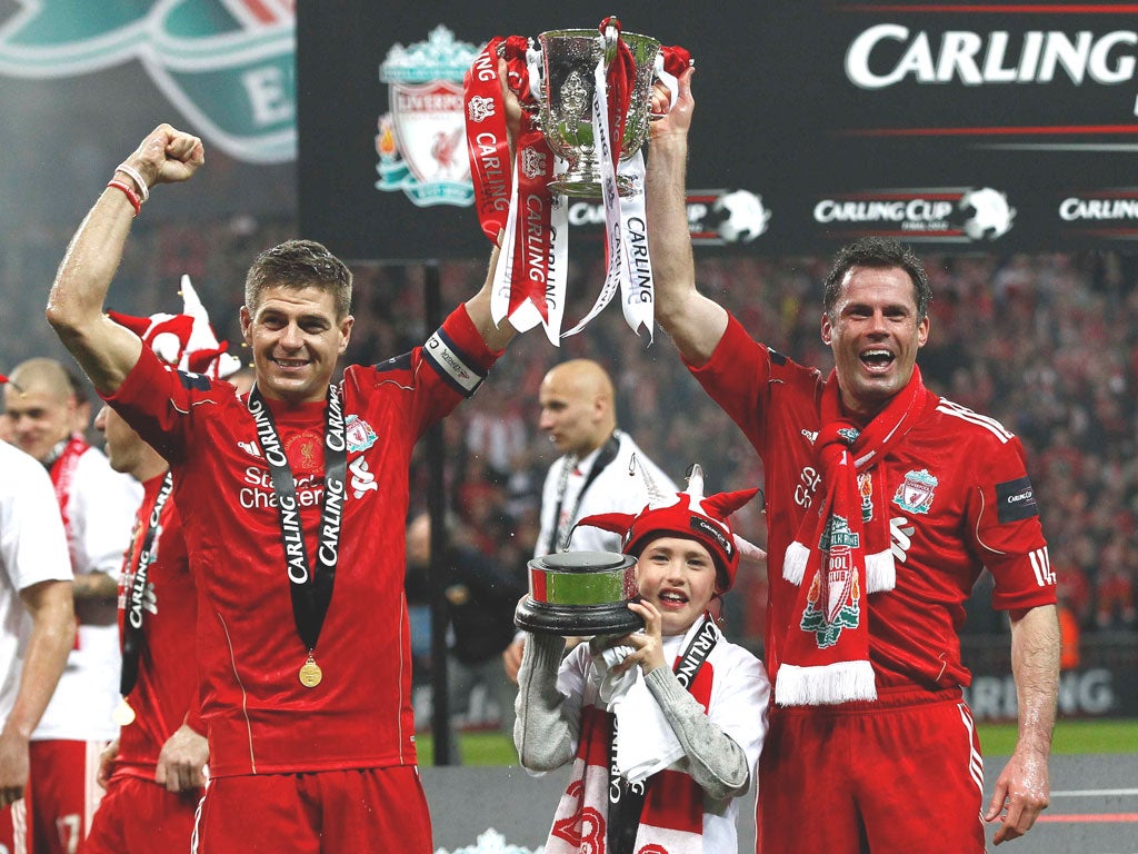 Jamie Carragher (right) celebrates the Carling Cup final victory with
fellow Liverpool stalwart Steven Gerrard last month