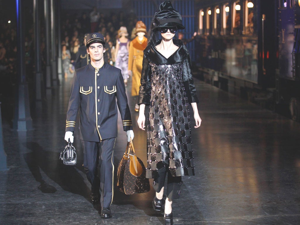Models wear creations by Marc Jacobs as part of his autumn/winter collection for Louis Vuitton in Paris where the audience was greeted with a spectacular life-size train