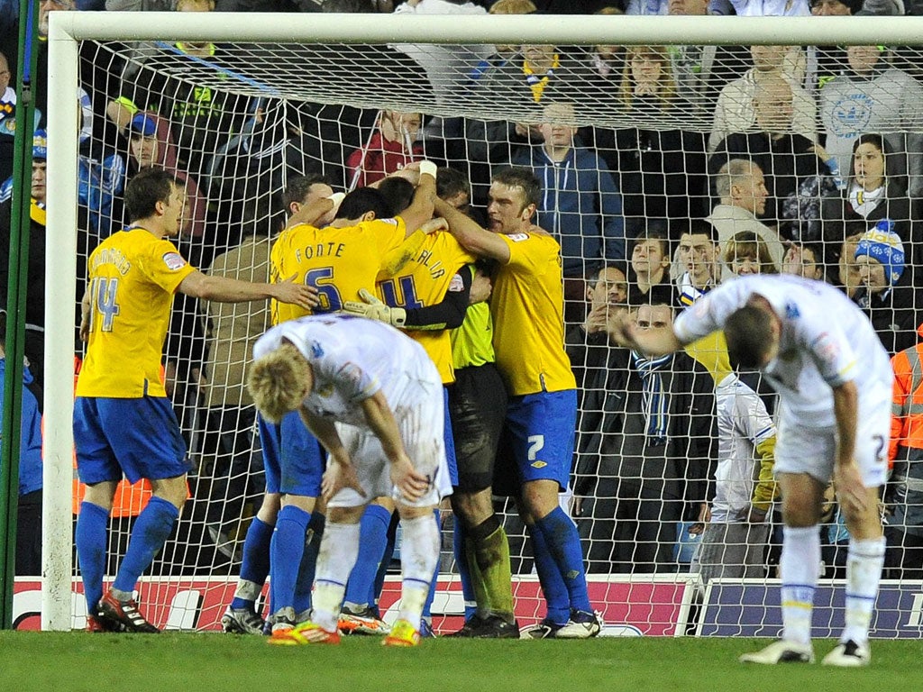 Southampton keeper Kelvin Davis is mobbed at the final whistle after almost single-handedly keeping Leeds at bay