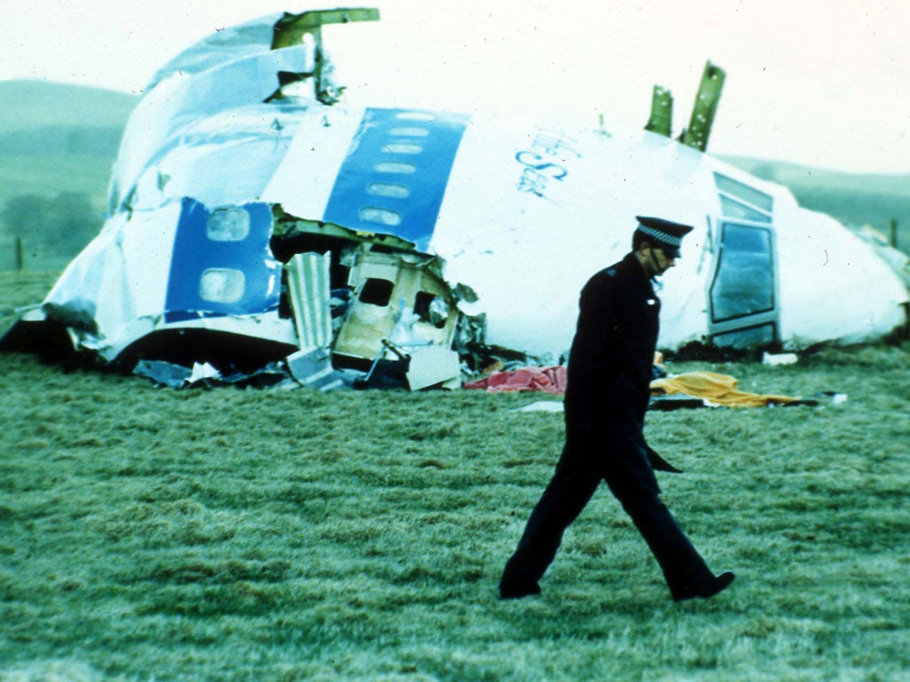 An officer walks past the wreckage in Lockerbie in 1988