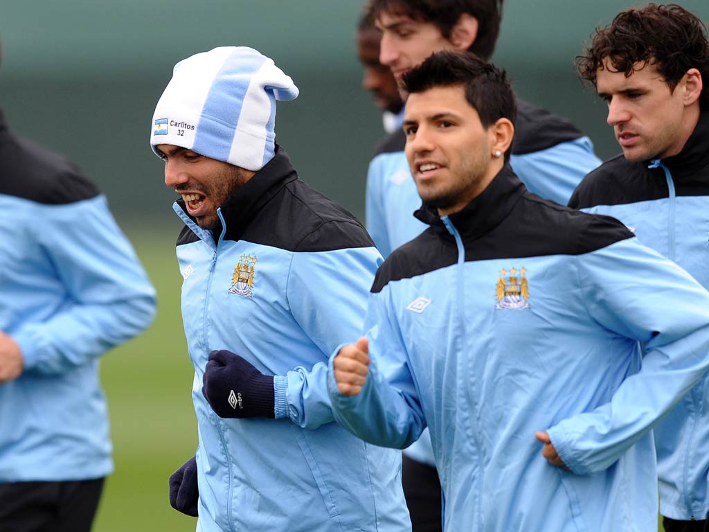 Carlos Tevez pictured training alongside Sergio Aguero this morning