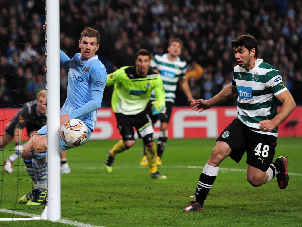 City goalkeeper Joe Hart looks on as his 95th-minute header grazes the Sporting post