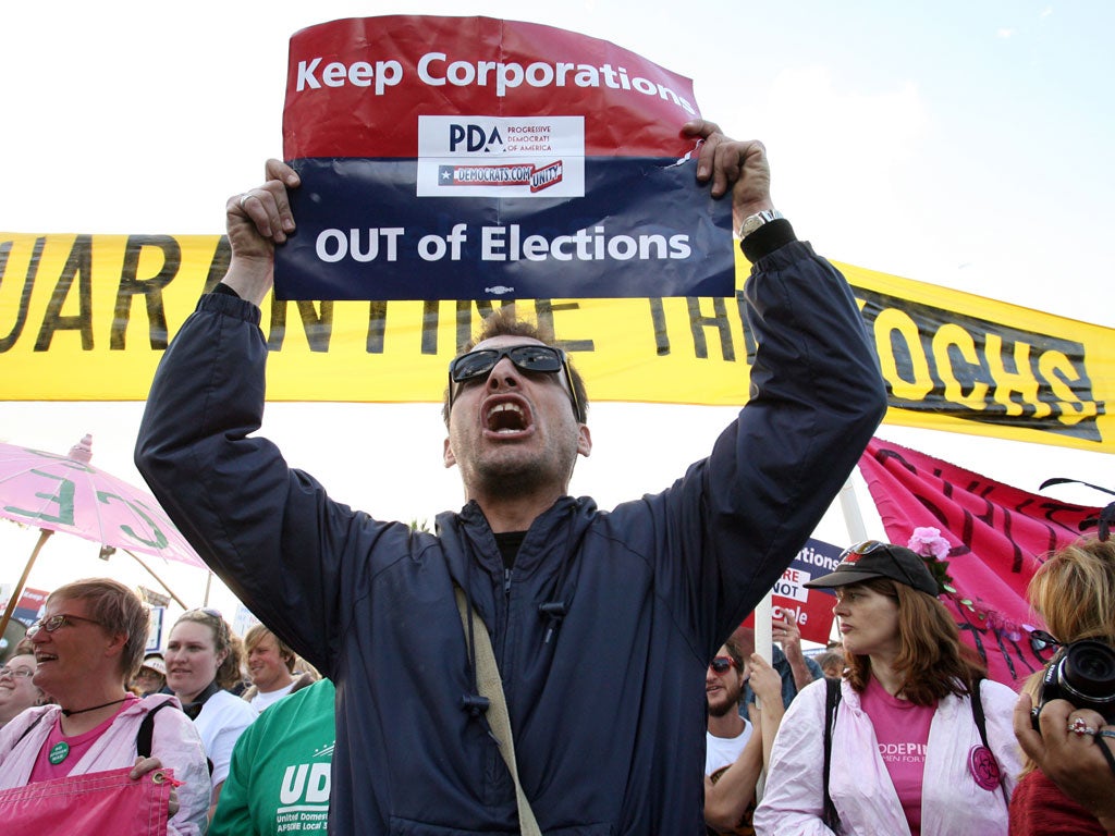 A protester outside the Kochs' ranch demonstrates against the involvement of big donors such as the billionaire brothers in shaping the political agenda