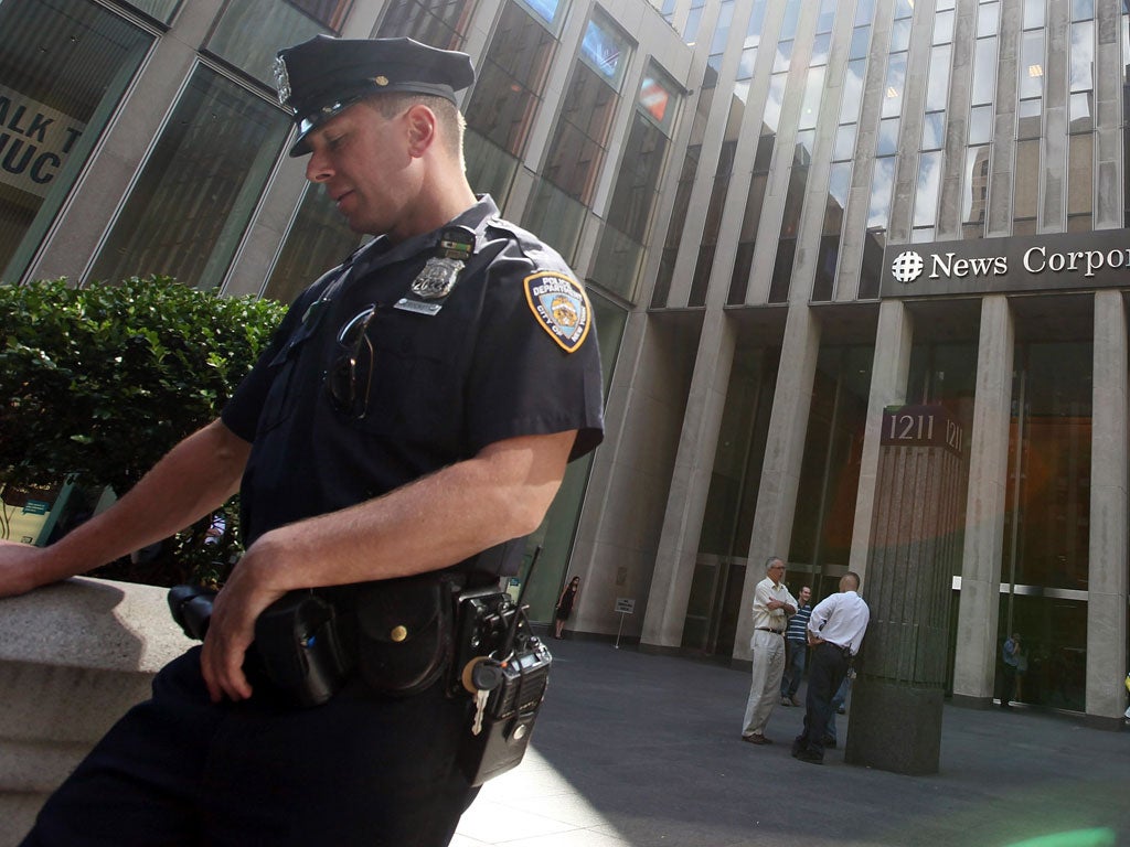 On Watch: A police officer outside News Corporation's HQ in Manhattan, New York last year