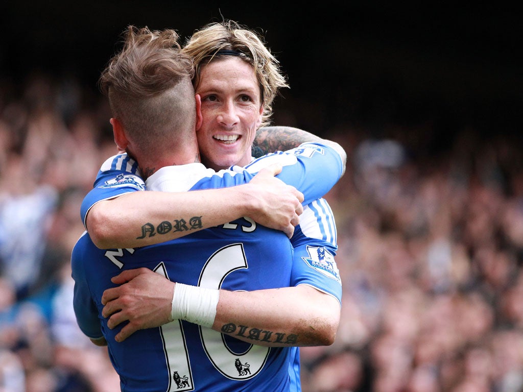 Torres is congratulated by Raul Meireles after his second goal at Stamford Bridge today