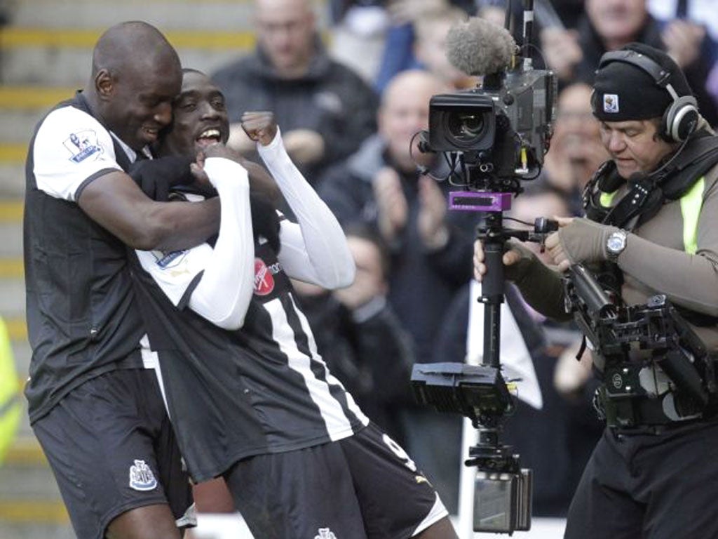 Papiss Cissé is embraced by his Senegal and Newcastle team-mate Demba Ba after his goal