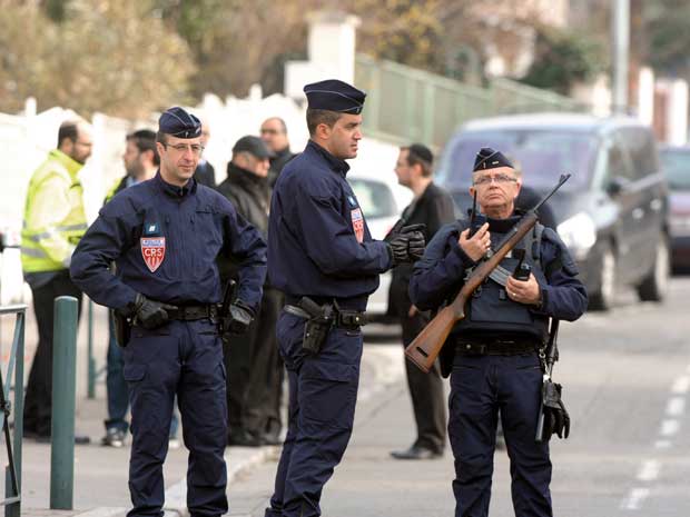 Policemen stand guard in front of the Ozar Hatorah Jewish school today