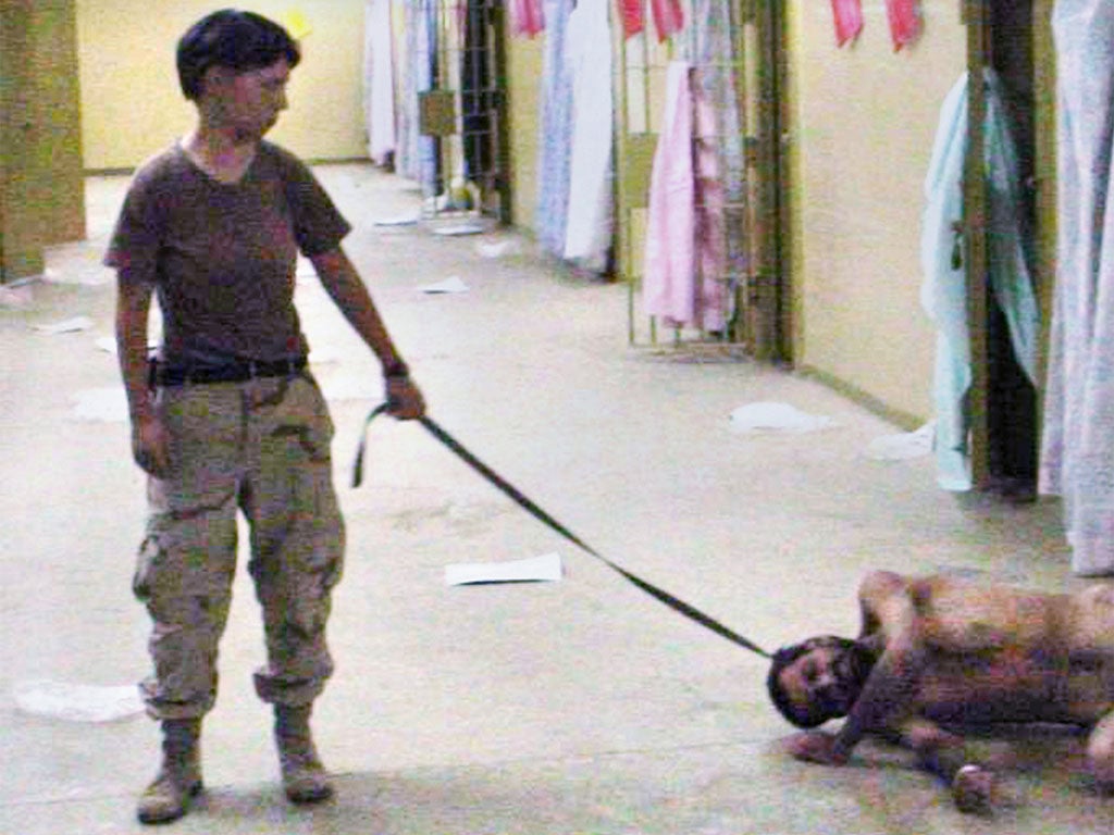 Lynndie England with a naked detainee at Abu Ghraib