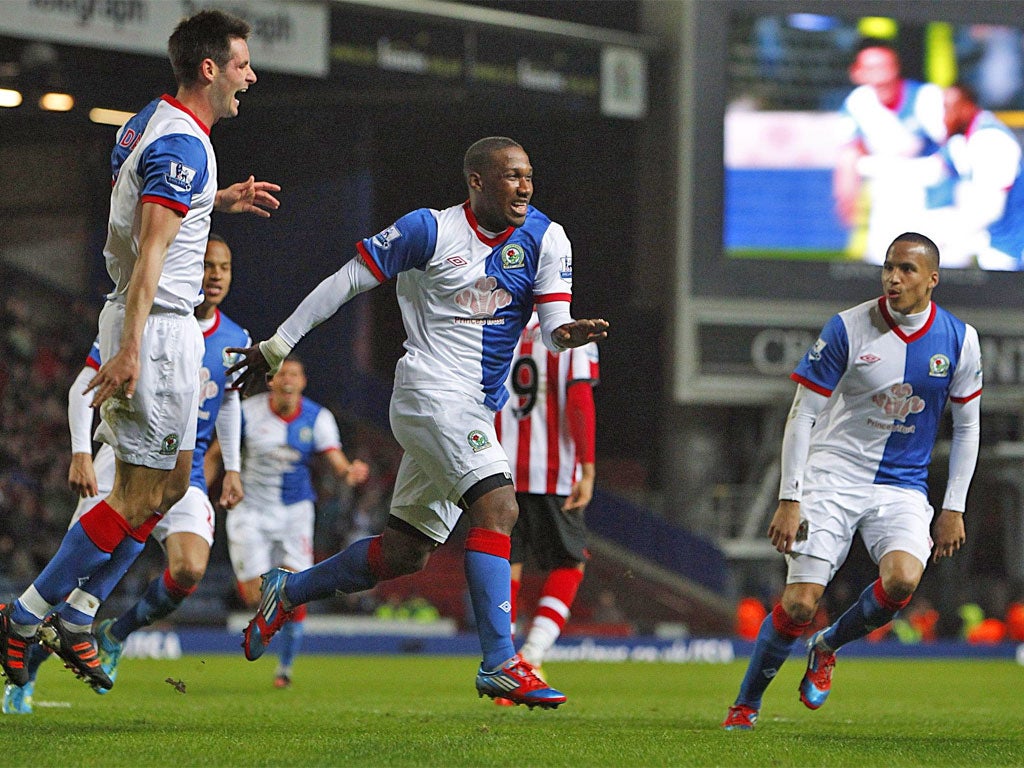 Junior Hoilett (centre) celebrates giving Blackburn Rovers the lead at Ewood Park last night