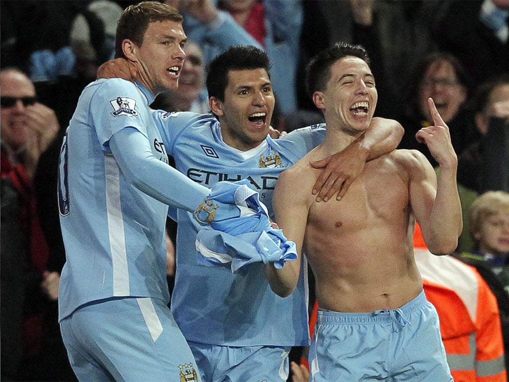 Samir Nasri (right) celebrates with Edin Dzeko (left) and Sergio Aguero