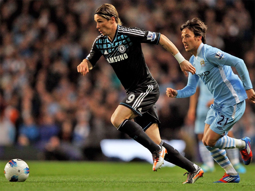 Chelsea striker Fernando Torres in full flight as David Silva gives chase at the Etihad Stadium last night