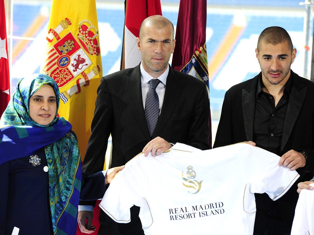 United Arab Emirates ambassador Hissa Abdullah Ahmed Al-Otaiba (left), fomer football player french Zinedine Zidane (centre) and Real Madrid's French forward Karim Benzema attend the Real Madrid resort presentation