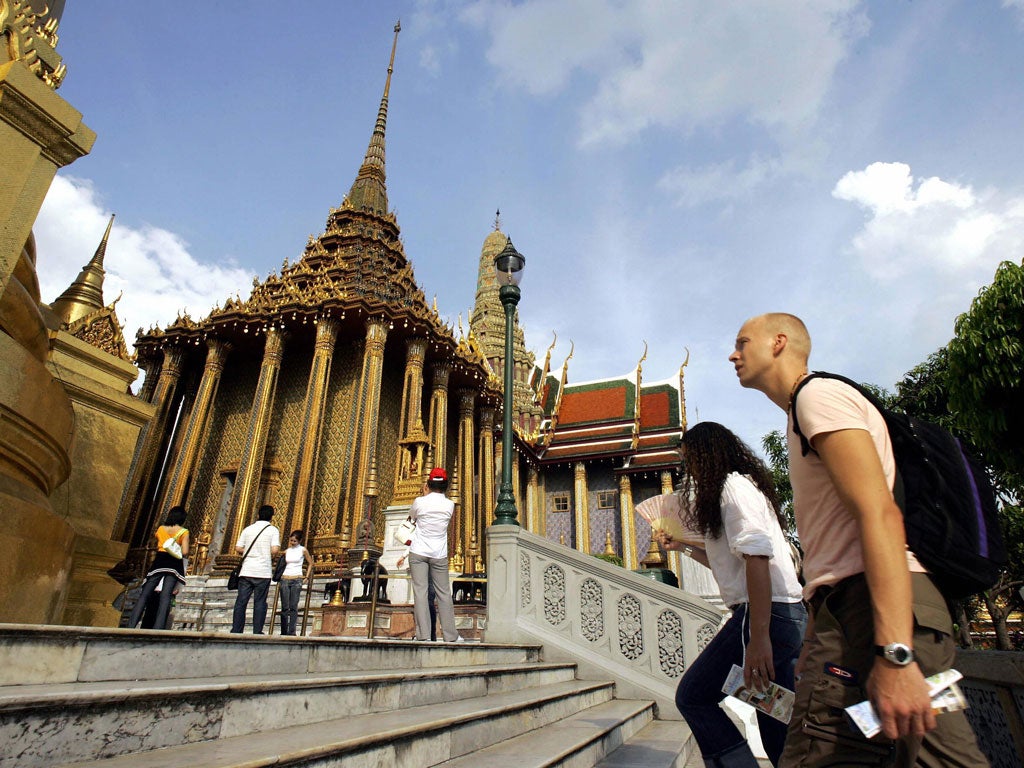 Foreign tourists visit the Emerald Buddha Temple at the Grand Palace in Bangkok