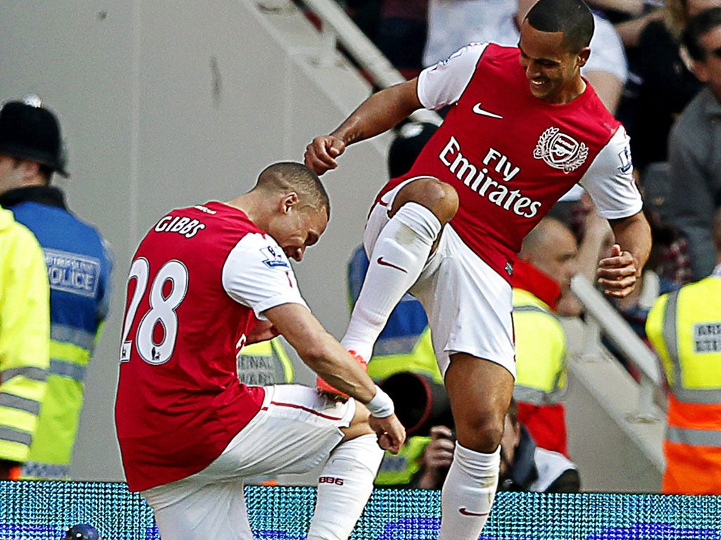 Knees up: Kieran Gibbs bows to Theo Walcott, another of Arsenal's goalscorers