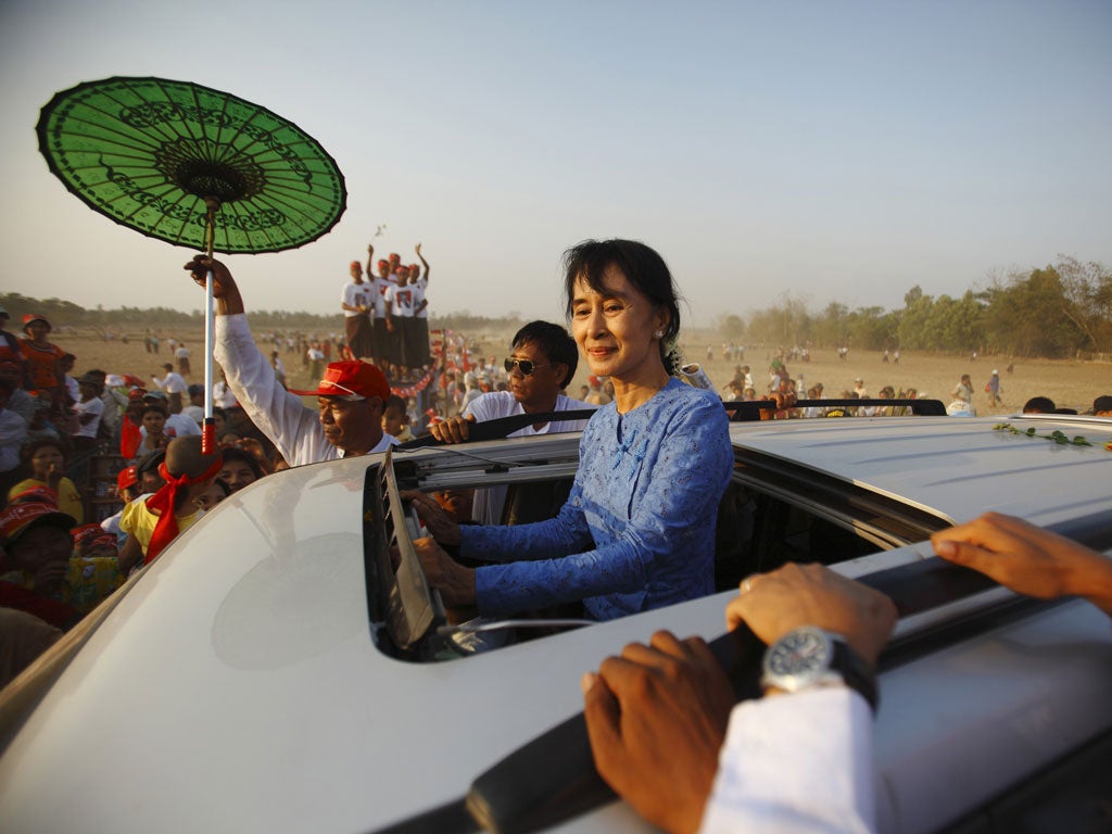 Aung San Suu Kyi greets supporters in Kawhmu township as Burma prepares to hold 48 by-elections