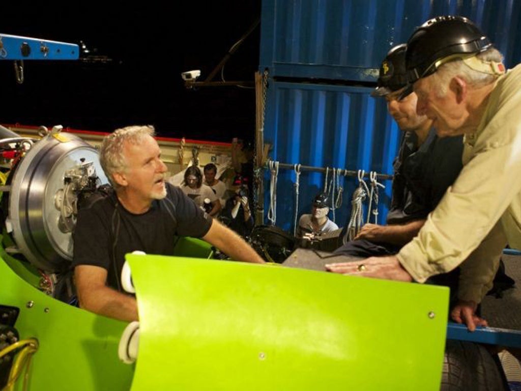 James Cameron (L) has a final conversation with Don Walsh (R) just before the hatch on the Deepsea Challenger submersible is closed