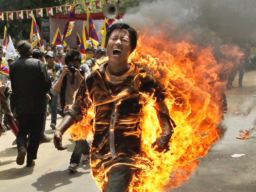 A Tibetan man set himself on fire and ran shouting through a demonstration in New Delhi yesterday