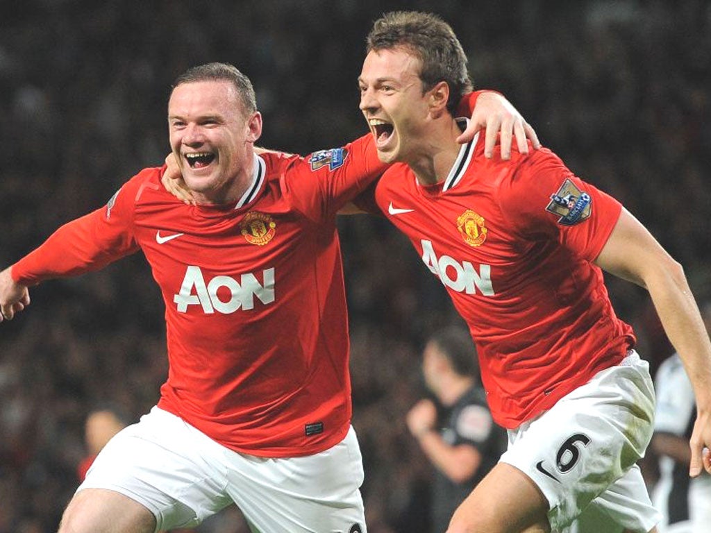 Wayne Rooney celebrates scoring the winner at Old Trafford with United team-mate Jonny Evans