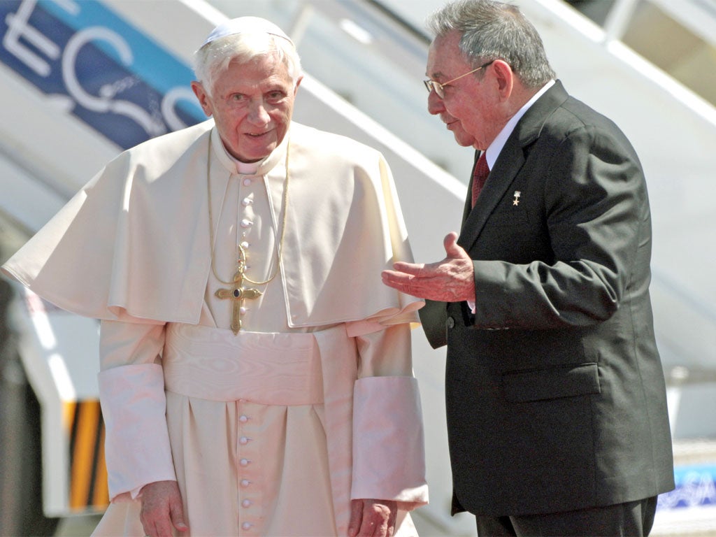 Pope Benedict XVI is greeted by President Raul Castro after flying in to Santiago de Cuba's airport