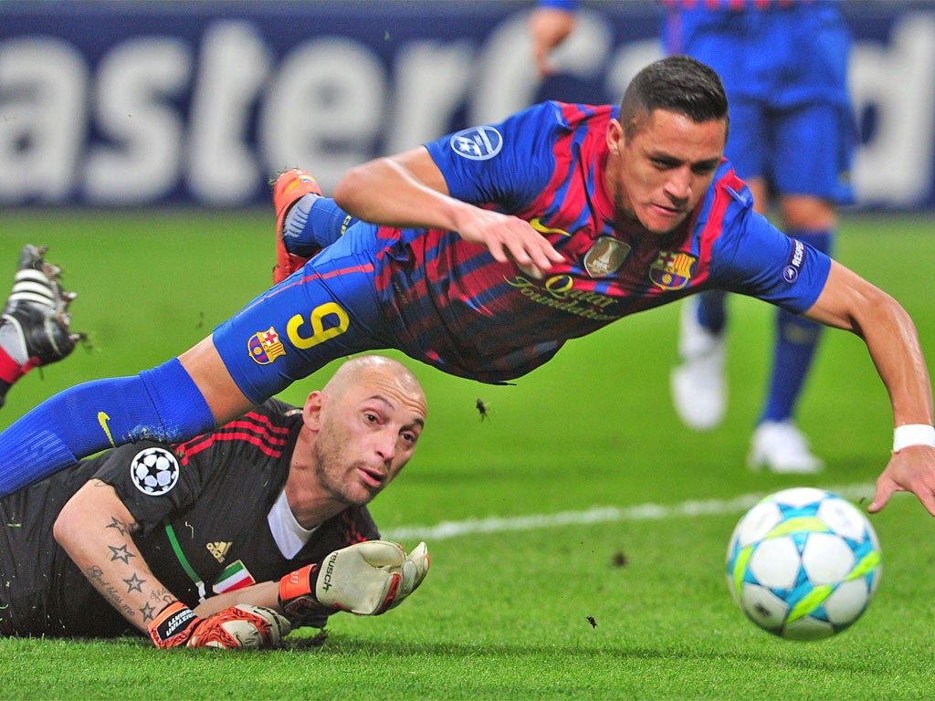 Barcelona's Alexis Sanchez falls down in the penalty area after being challenged by Milan keeper Chistian Abbiati. No penalty was given