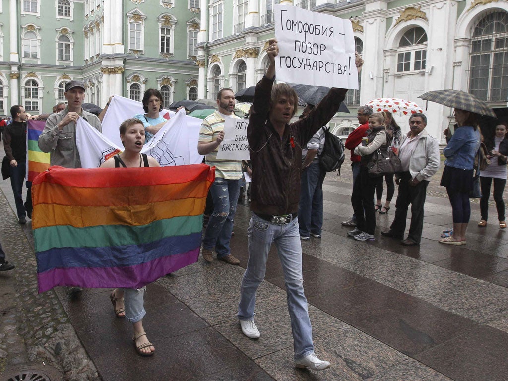 Gay rights activists protest in St Petersburg with banners reading 'Homophobia is a shame on the State'