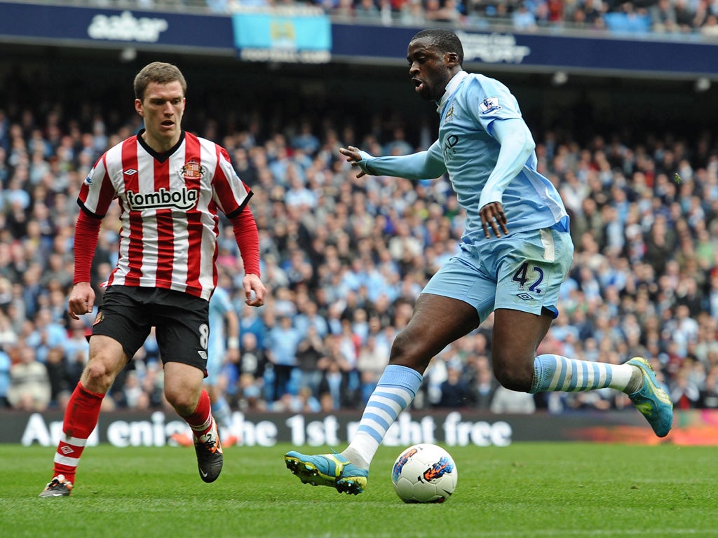 City's Yaya Toure vies with Sunderland's midfielder Craig Gardner