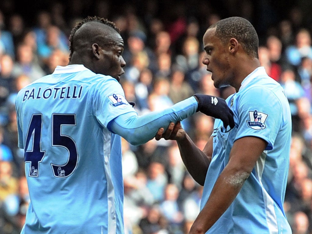 Blue Murder: Mario Balotelli (left) is told off by his captain, Vincent Kompany, after a spat with his team-mate Aleksandar Kolarov