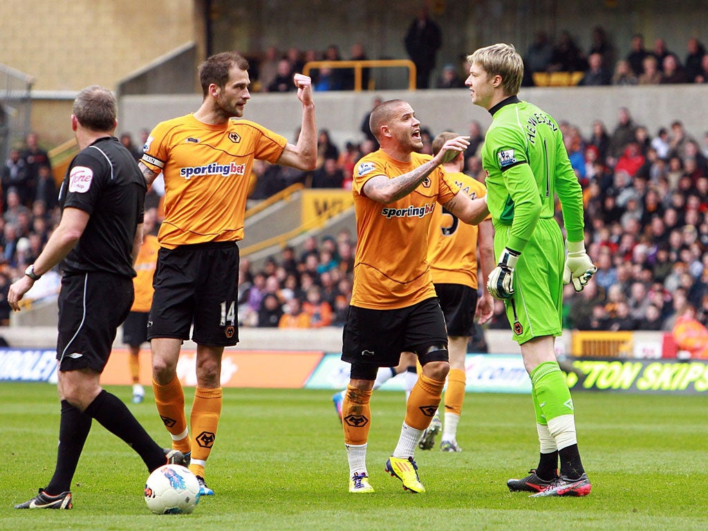 Baying Wolves: Roger Johnson (left) confronts his own goalkeeper Wayne Hennessey as the tension mounts at Molineux