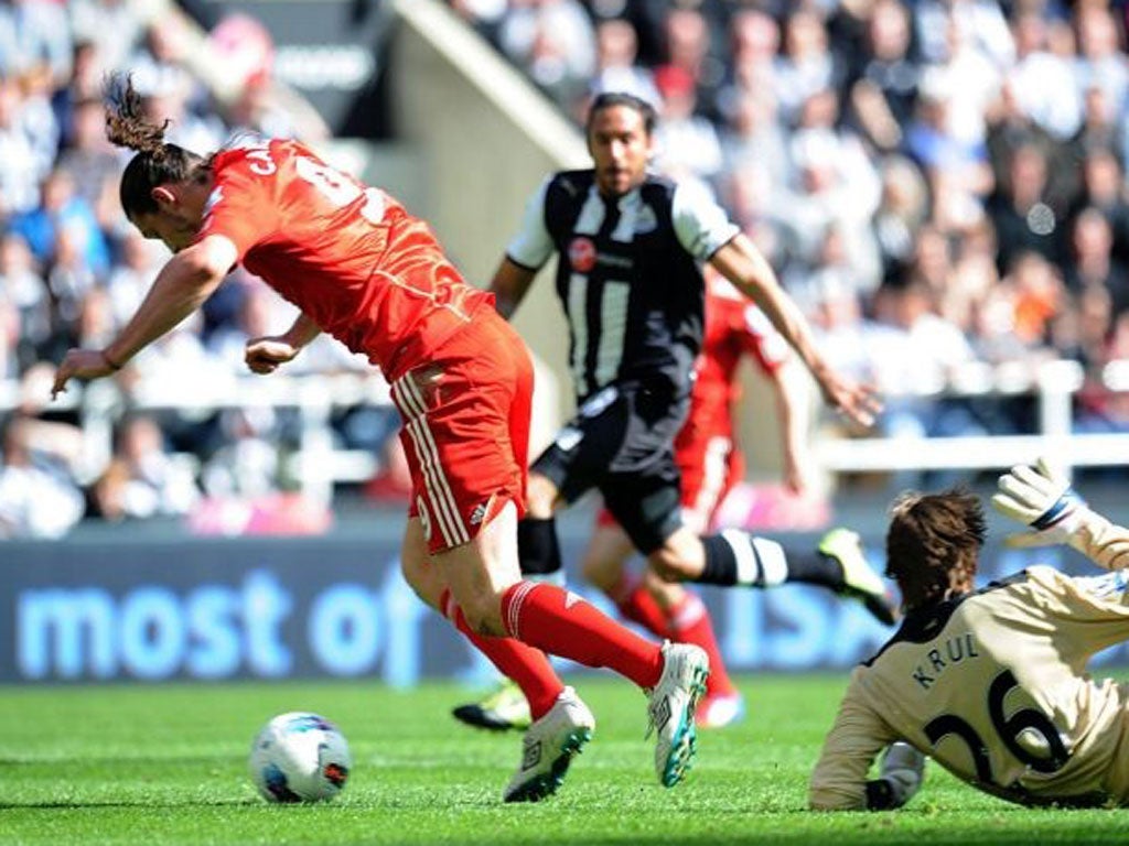 Liverpool’s Andy Carroll tumbles to the ground in the penalty area
and is booked for diving on his return to St James’ Park