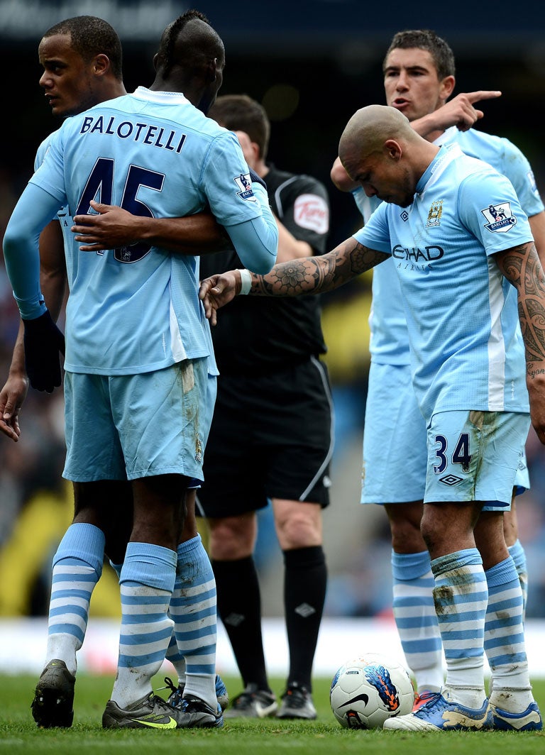 31 March 2012 The pressure of the title race seems to be getting to Man City as Mario Balotelli has to be restrained by Vincent Kompany after arguing with Aleksandar Kolarov about taking a free kick. Man City were 3-1 down with five minutes to