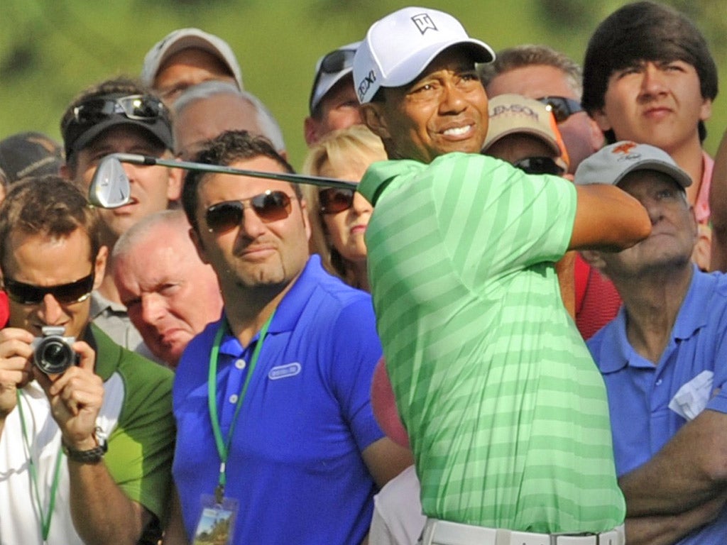 Tiger Woods gets used to his irons during a practice round before today's start of the 2012 Masters at Augusta
